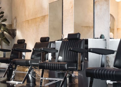 Modern barber chairs at Brother Wolf Fitzroy in Melbourne, Victoria, AU, showcasing a stylish interior.