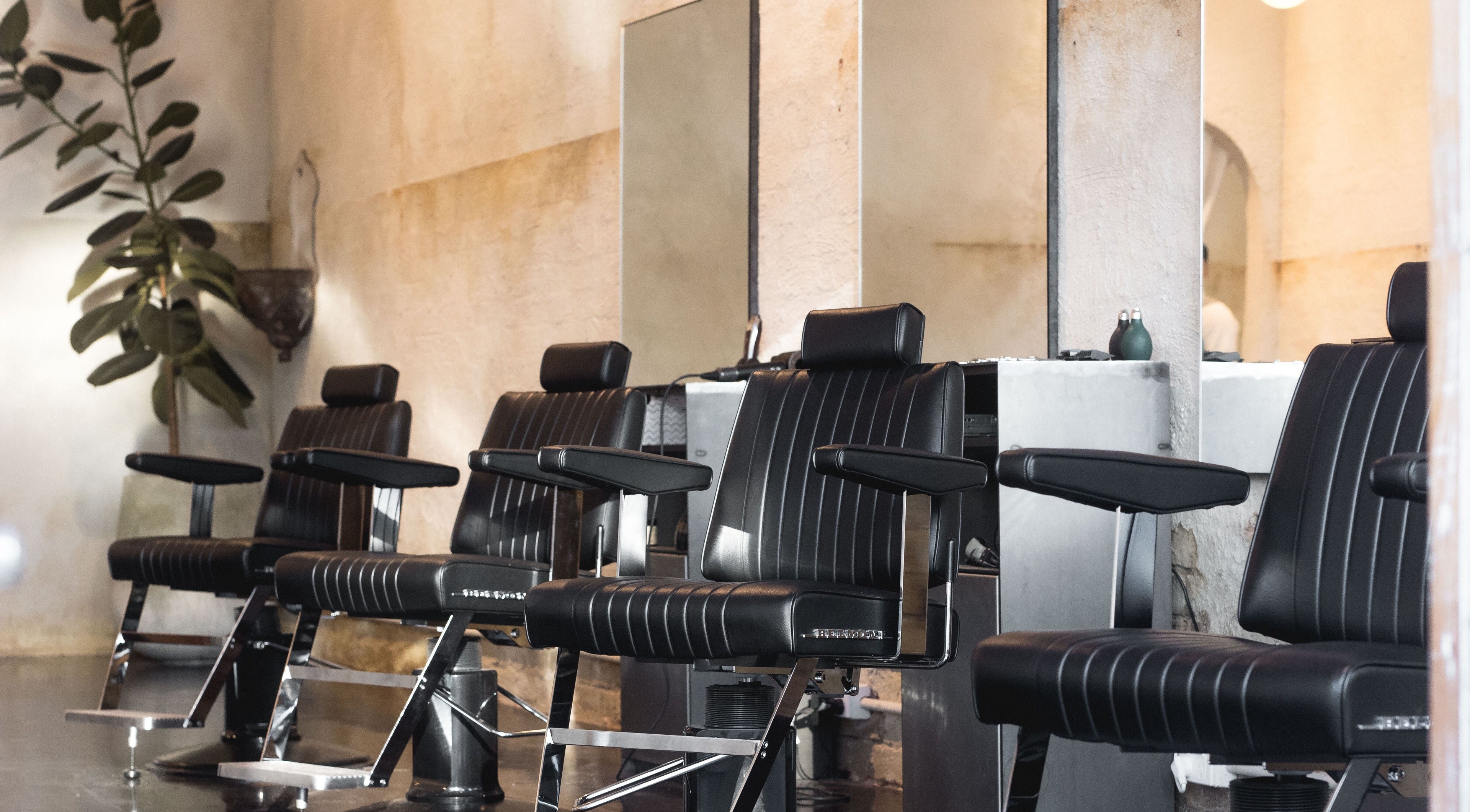 Modern barber chairs at Brother Wolf Fitzroy in Melbourne, Victoria, AU, showcasing a stylish interior.