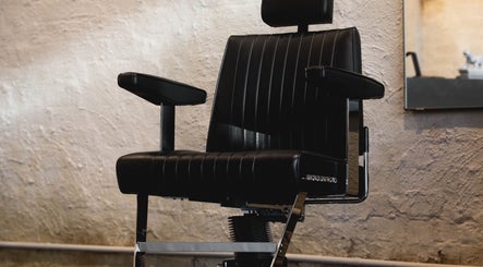 Elegant black barber chair at Brother Wolf Fitzroy, Melbourne, Victoria, AU, showcasing style and comfort.
