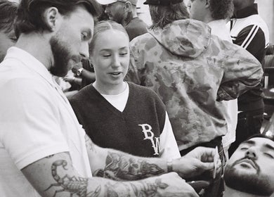 Barber trimming beard at Brother Wolf Prahran, Prahran, Victoria, AU amidst a lively atmosphere.