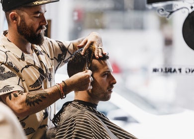 Barber styling hair at Brother Wolf Prahran, Prahran, Victoria, AU, perfect grooming experience.