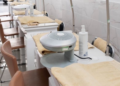 Modern nail stations at Brick Lane Nail Spa, London, England, GB, showcasing stylish seating and equipment.