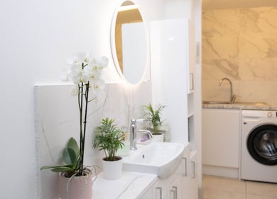 Elegant restroom at Brick Lane Nail Spa, London, England, GB with orchids and modern fixtures.