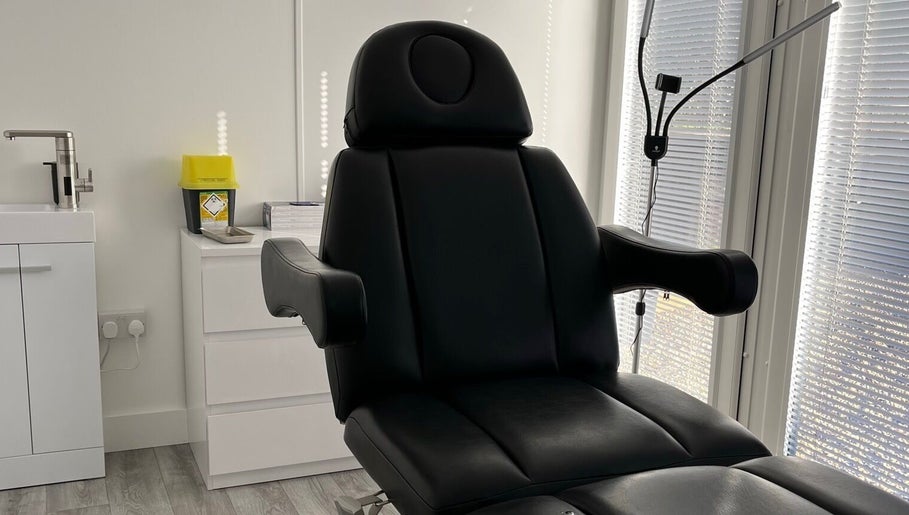 Modern black treatment chair at Nurse Injector Michelle, Lowestoft, England, GB. Sleek and inviting.