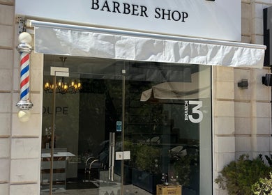 Entrance of Le Coupe 3 barber shop with classic pole in عمّان, محافظة العاصمة, JO.