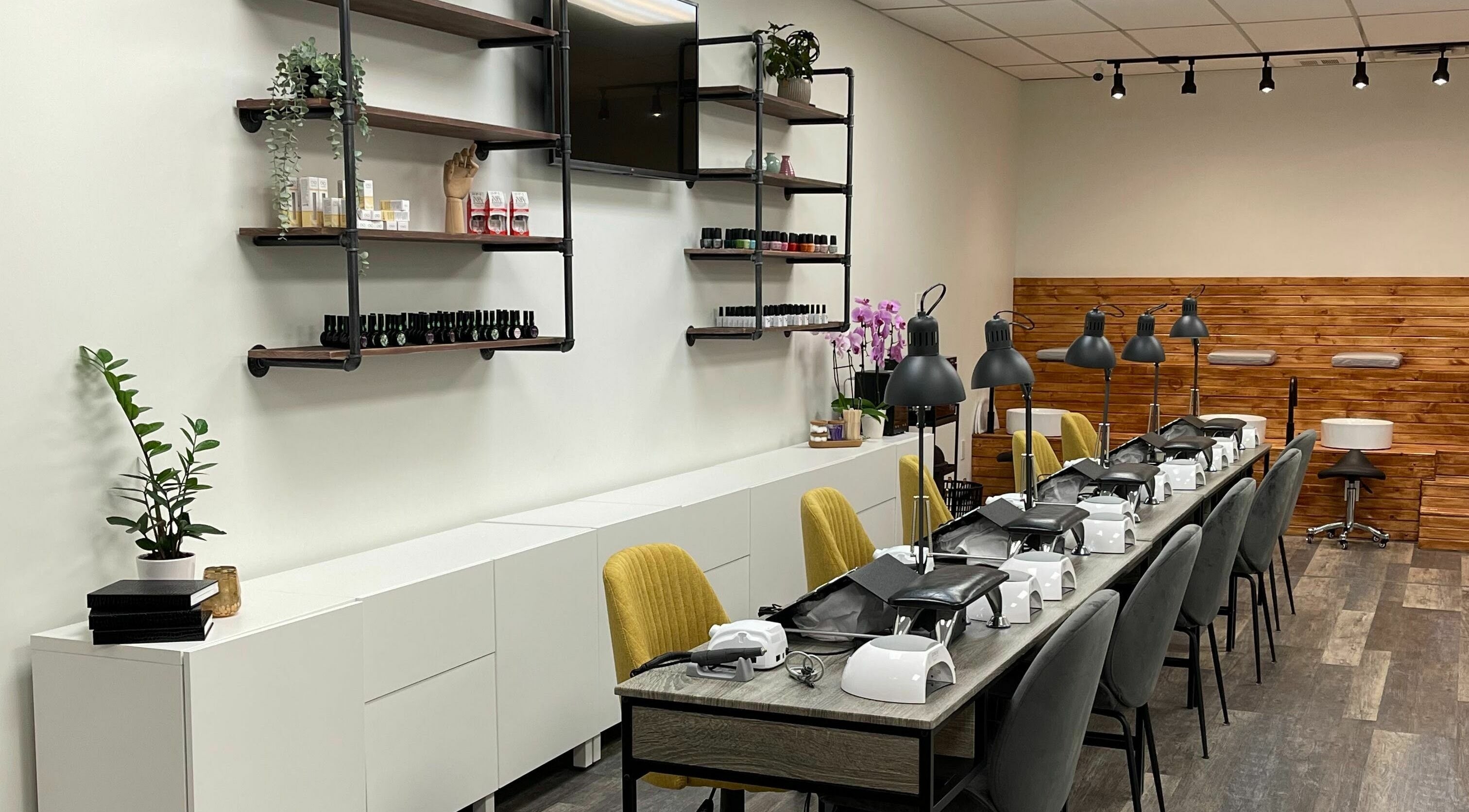 Modern nail salon setup at Beauty By Fahimeh, Toronto, Ontario, CA with stylish decor and seating.