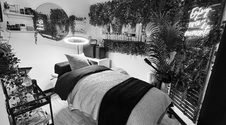 Tranquil treatment room at Sie Skin Spa, Stalybridge, England, GB, with lush greenery and cozy bed.