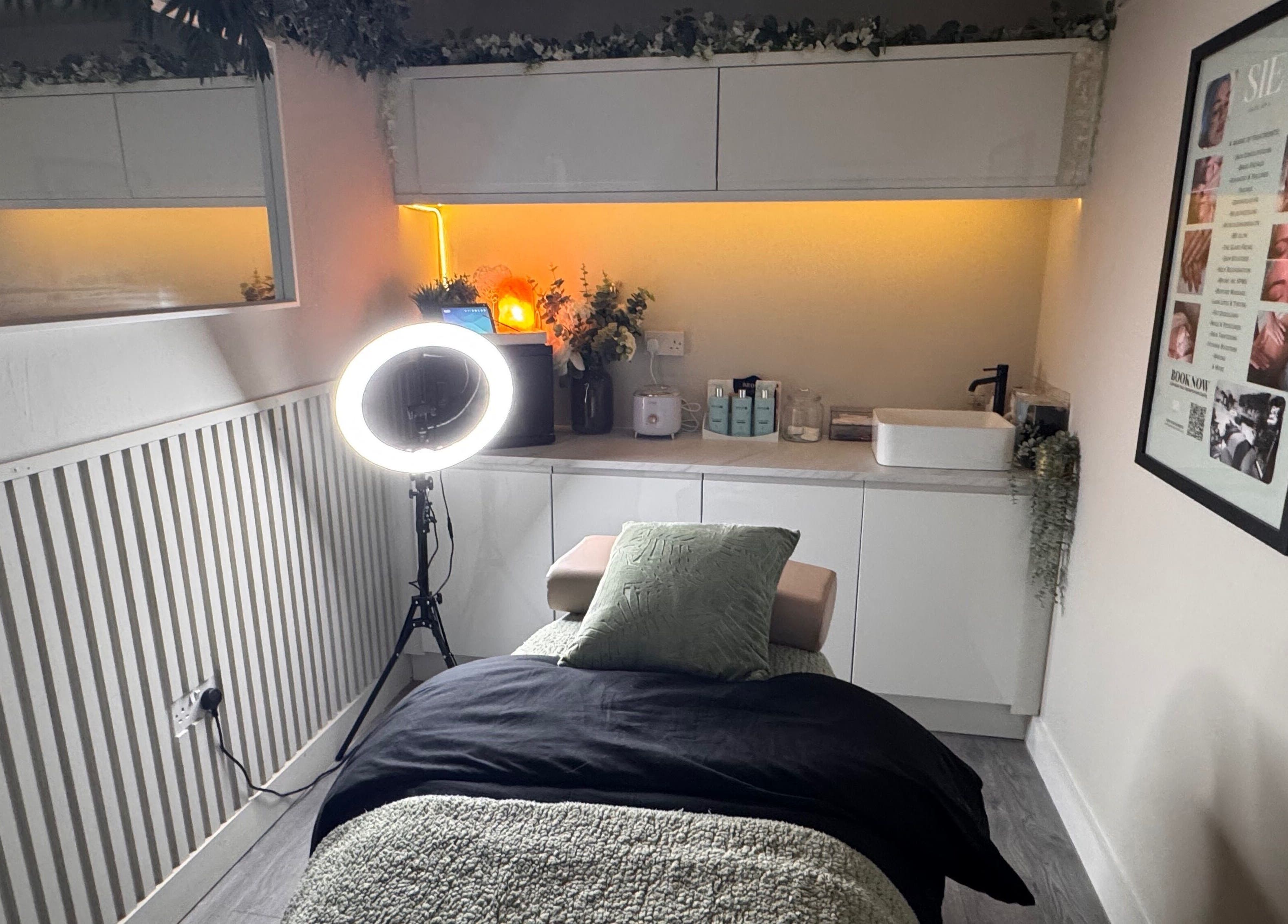 Relaxing treatment room at Sie Skin Spa in Stalybridge, England, GB, featuring a comfortable massage table and ambient lighting.