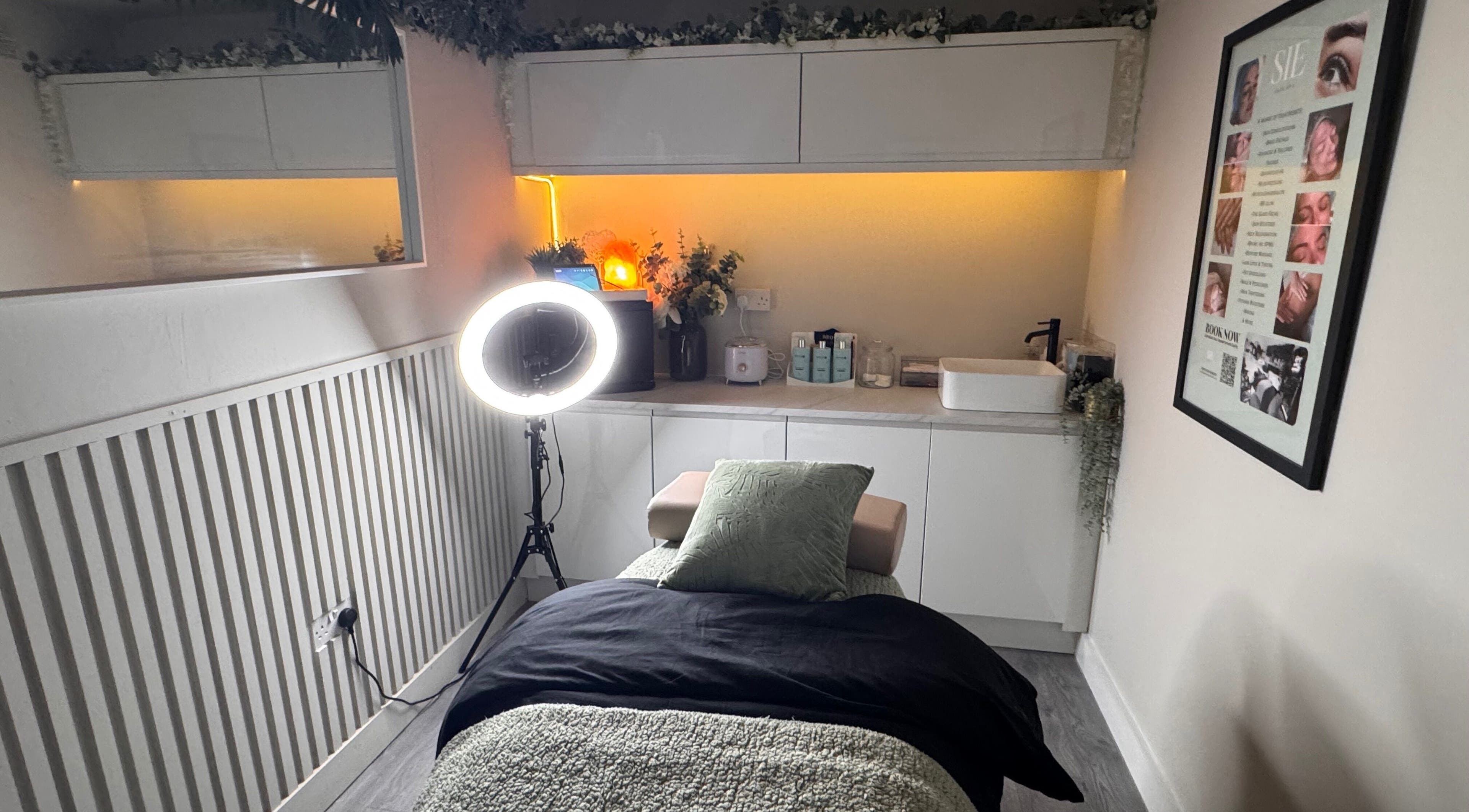 Relaxing treatment room at Sie Skin Spa in Stalybridge, England, GB, featuring a comfortable massage table and ambient lighting.