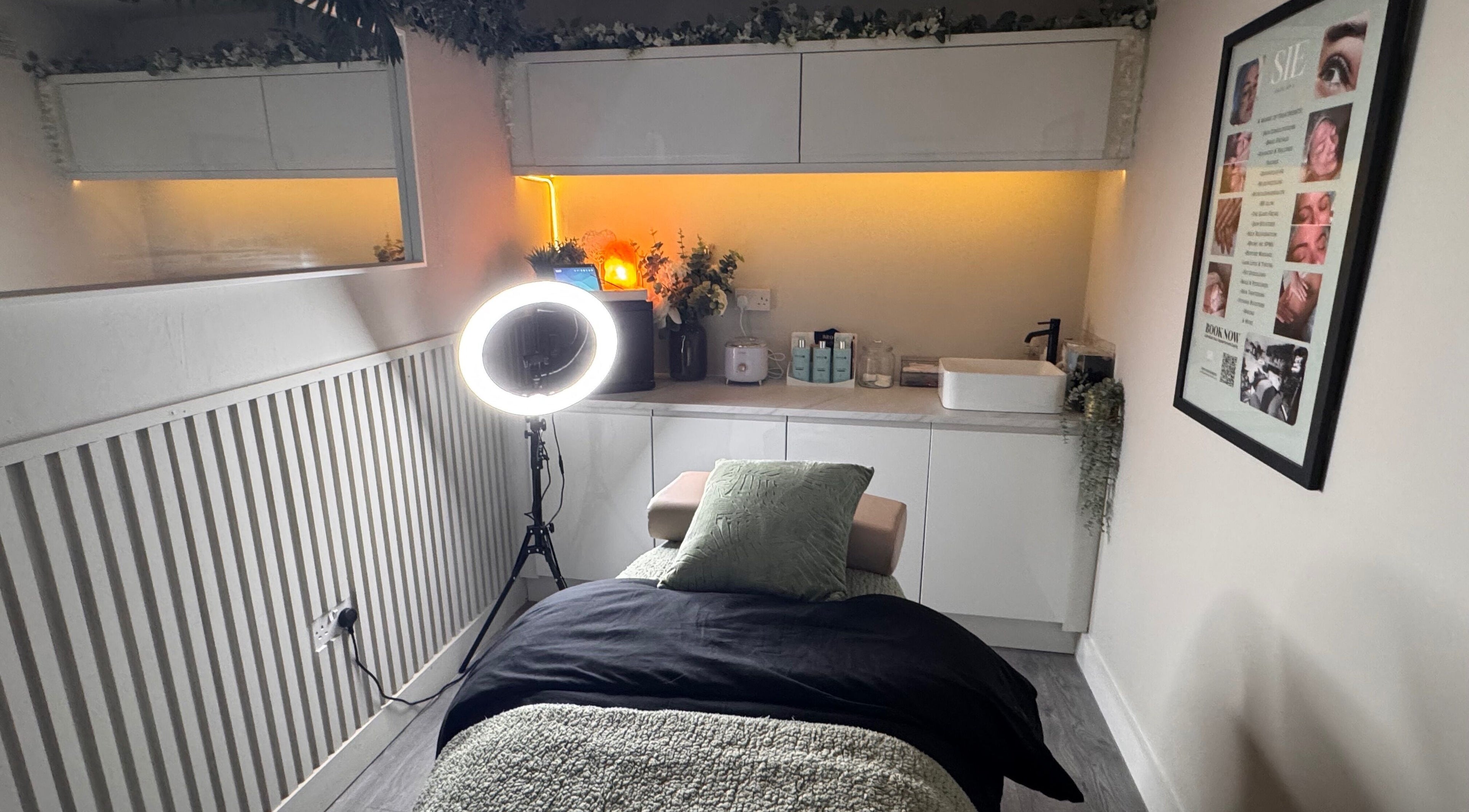 Relaxing treatment room at Sie Skin Spa in Stalybridge, England, GB, featuring a comfortable massage table and ambient lighting.