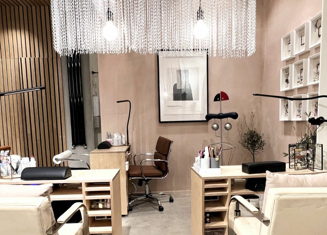 Elegant nail salon interior at Haco 箱 Nails, London, England, GB, showcasing modern decor and comfortable seating.