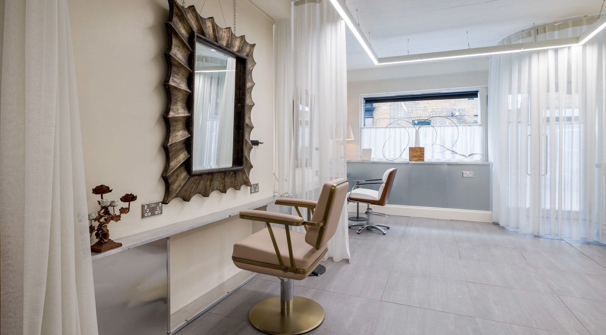 Elegant hair salon space at Haco 箱 Hair + Nails Hoxton, London, England, GB with stylish decor and lighting.