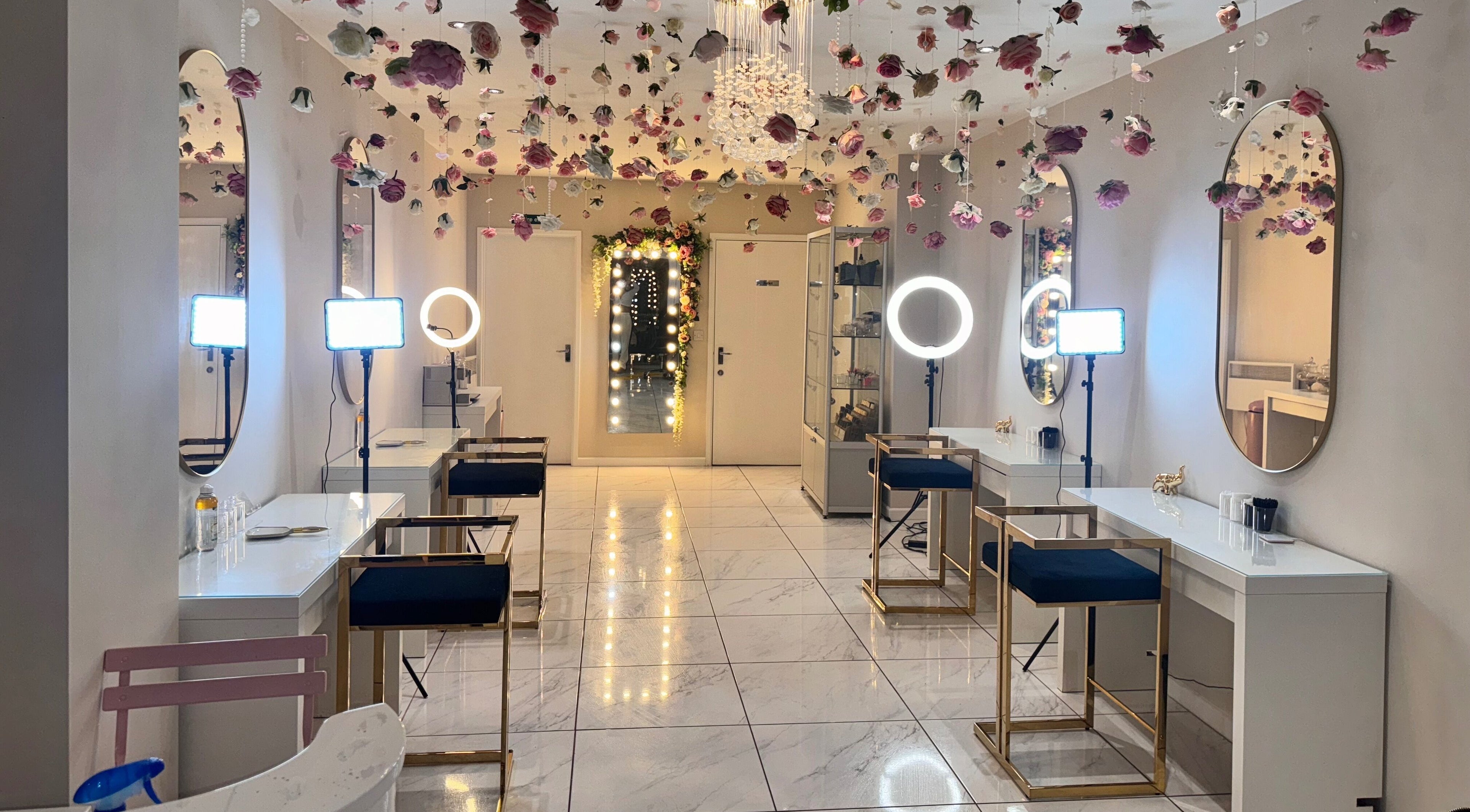 Glamorous interior of Makeup Mobile To You Studio in Stockport, England, GB with hanging florals and elegant seating.