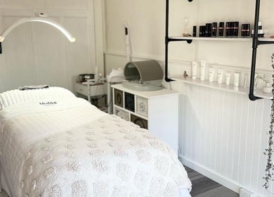 Relaxing treatment room at Skin Wellness Clinic, Highett, Victoria, AU, featuring a spa bed and skincare products.
