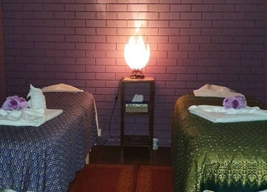 Tranquil massage room at Smiling Thai Therapy & Massage, Wynnum, Queensland, AU with soft lighting and cozy beds.