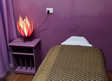 Cozy therapy room at Smiling Thai Therapy & Massage, Wynnum, Queensland, AU with purple tones and ambient lighting.