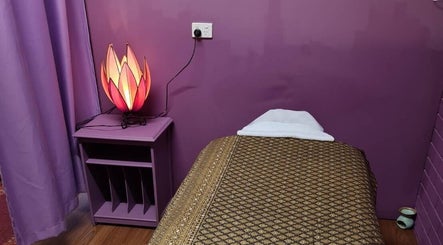 Cozy therapy room at Smiling Thai Therapy & Massage, Wynnum, Queensland, AU with purple tones and ambient lighting.