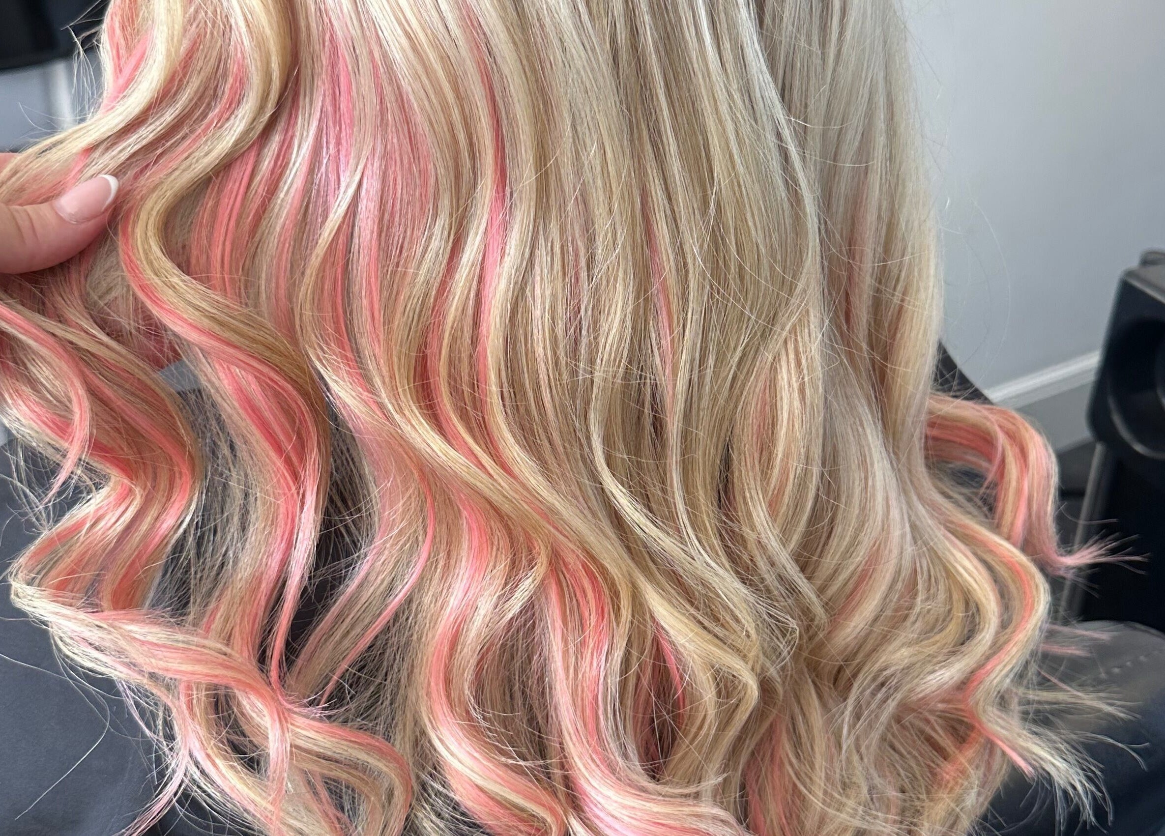 Stylish blonde hair with pink highlights at Lush Hair and Nails, Stockton on Tees, England, GB.