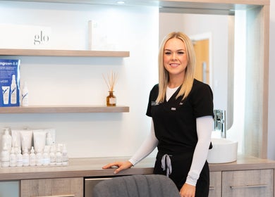 Staff member at The London Road Clinic in Newark-on-Trent, England, GB, showcasing beauty products.