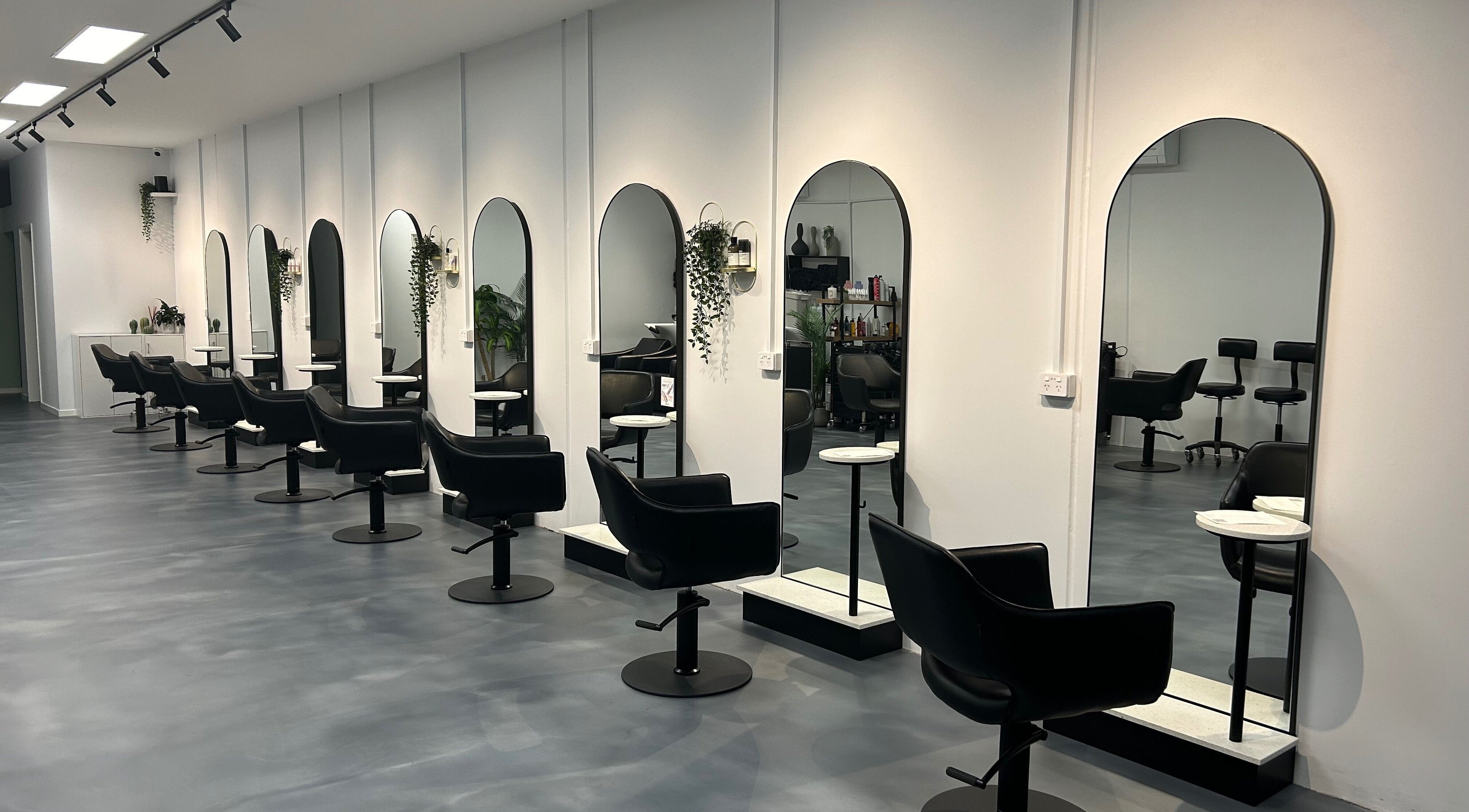 Modern salon chairs and mirrors at Revolutions Hair Studio, Melbourne, Victoria, AU, offering stylish hair services.