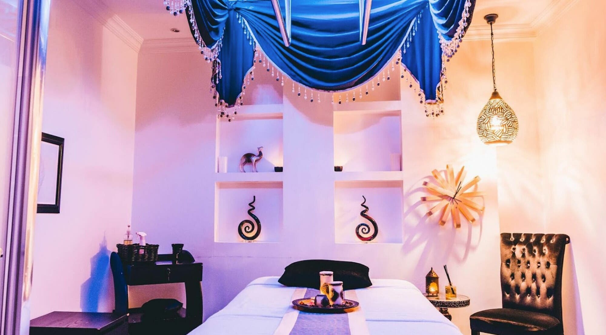 Luxurious treatment room at Alafiya Center for Hamam & Saloon in Abu Dhabi, AE with elegant decor and lighting.