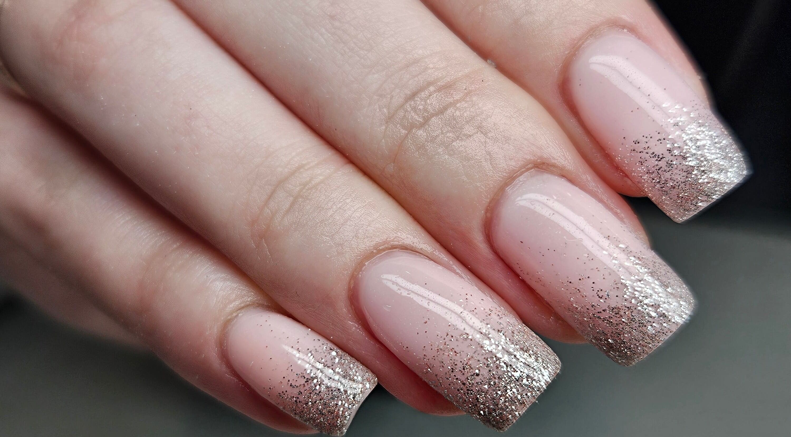 Glitter nail art at The Natural Nail Club, Long Eaton, England, GB showcases elegant manicure style.