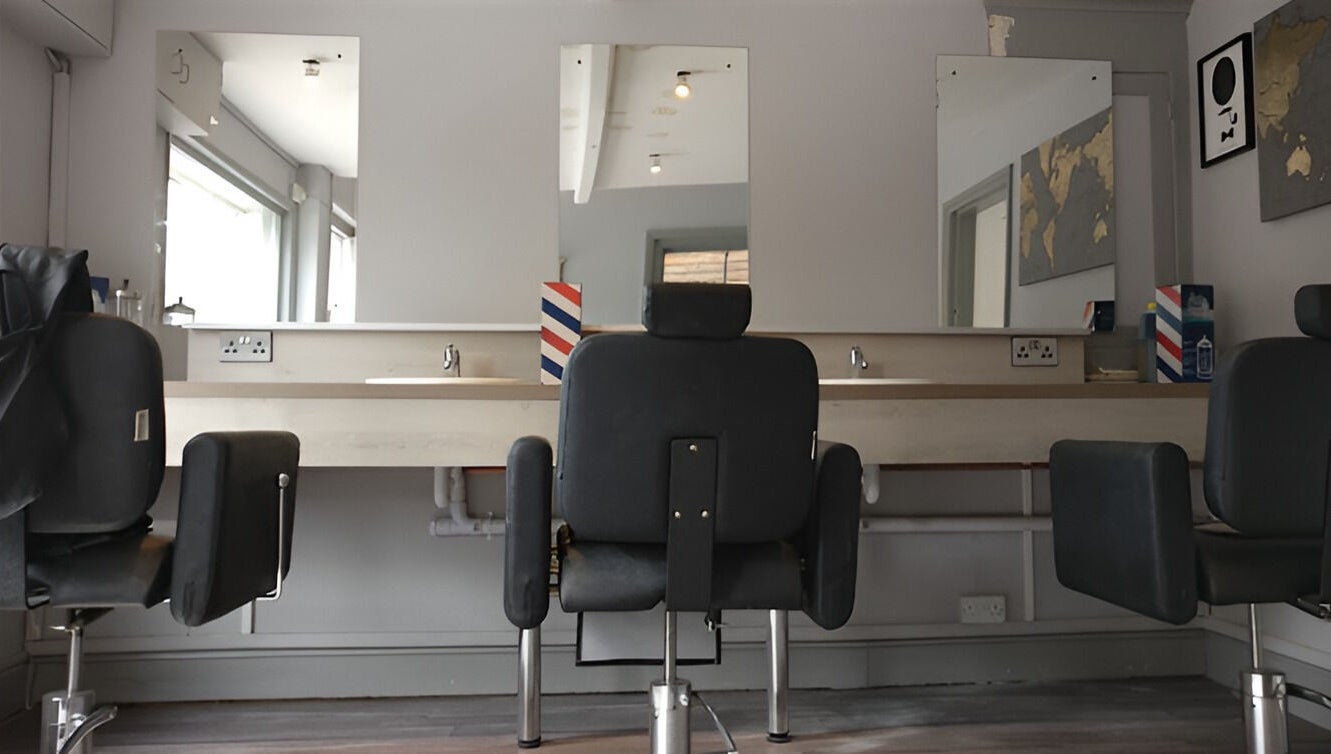 Chic salon interior at Herkymoo Herstmonceux, Herstmonceux, England, GB with modern styling chairs and mirrors.