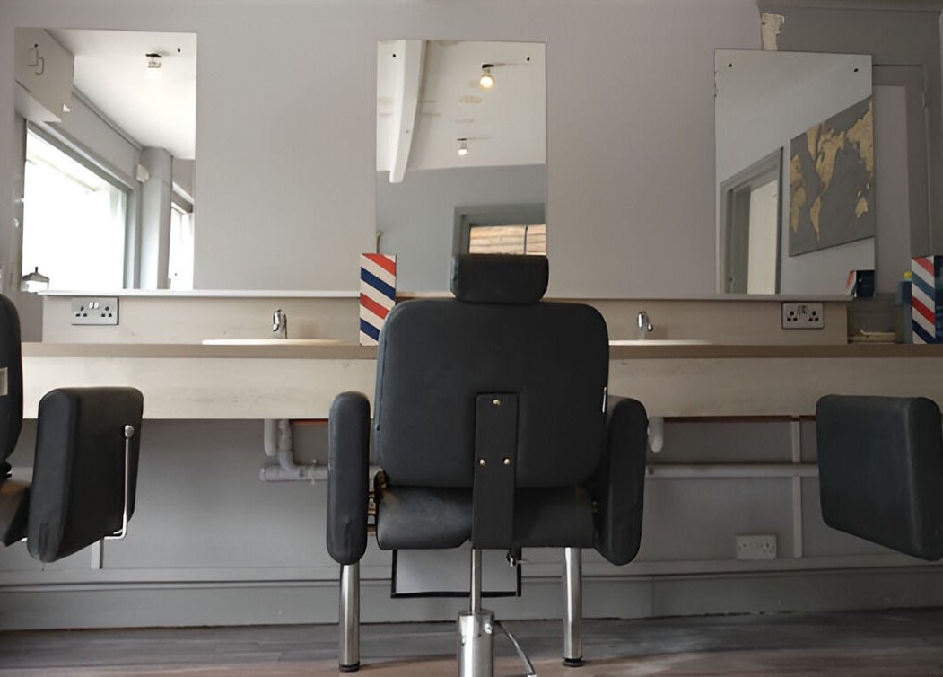 Chic salon interior at Herkymoo Herstmonceux, Herstmonceux, England, GB with modern styling chairs and mirrors.