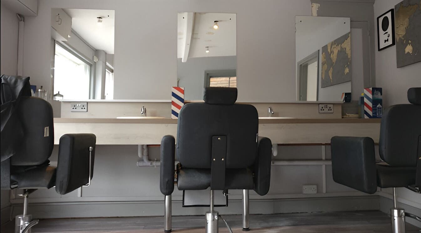 Chic salon interior at Herkymoo Herstmonceux, Herstmonceux, England, GB with modern styling chairs and mirrors.