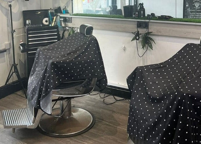 Stylish barber chairs at Herkymoo Herstmonceux, Herstmonceux, England, GB, offering a modern grooming experience.