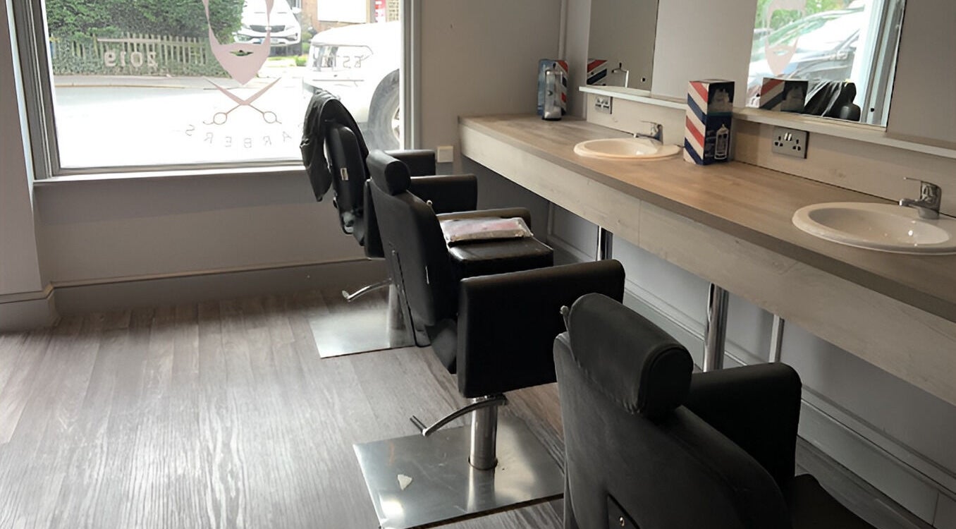 Stylish barber chairs at Herkymoo Herstmonceux in Herstmonceux, England, GB, offering a modern and relaxing atmosphere.