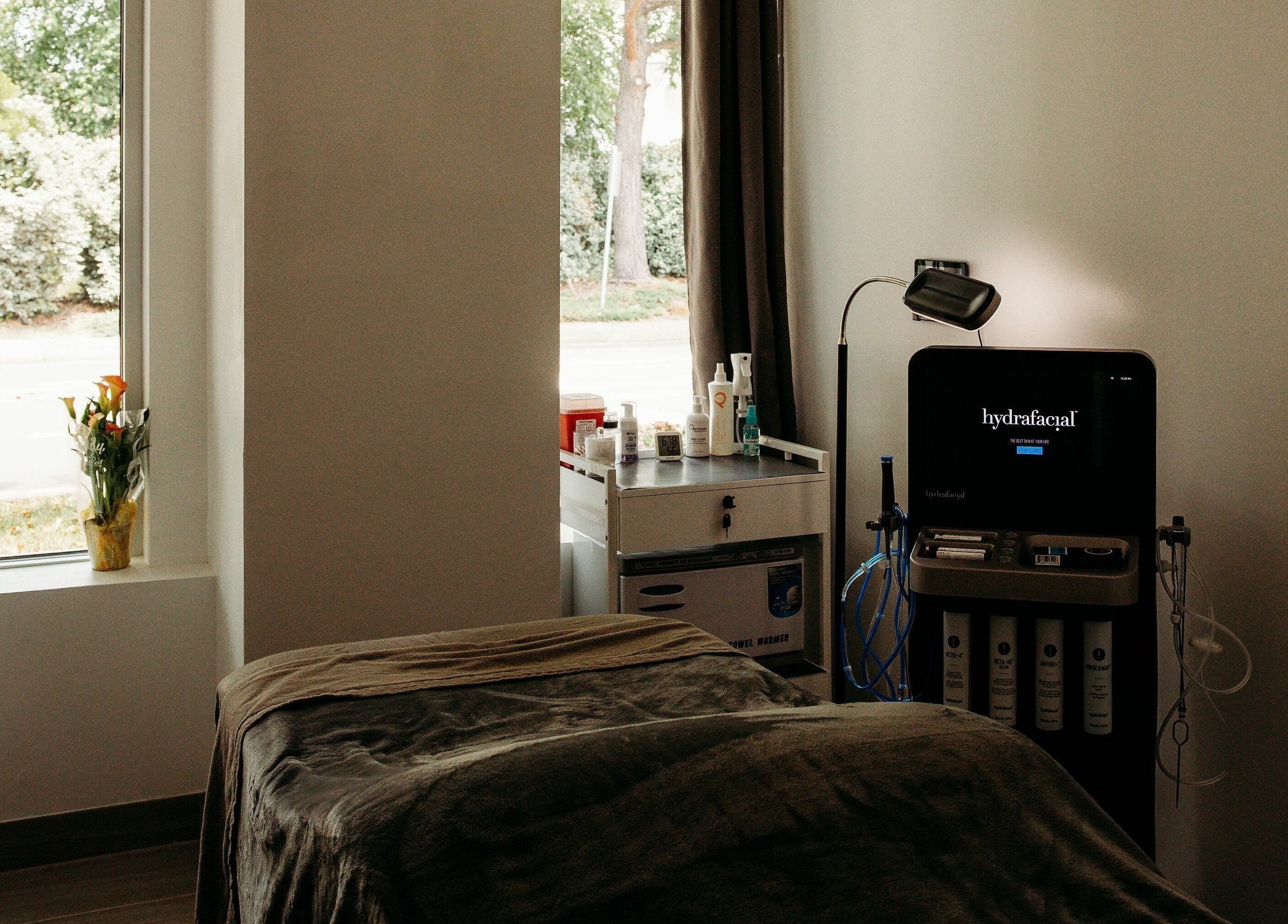 Relaxing spa room at At Marina Shores - Vogue Lashes and Spa, Virginia Beach, Virginia, US, with sunlight and hydrafacial machine.