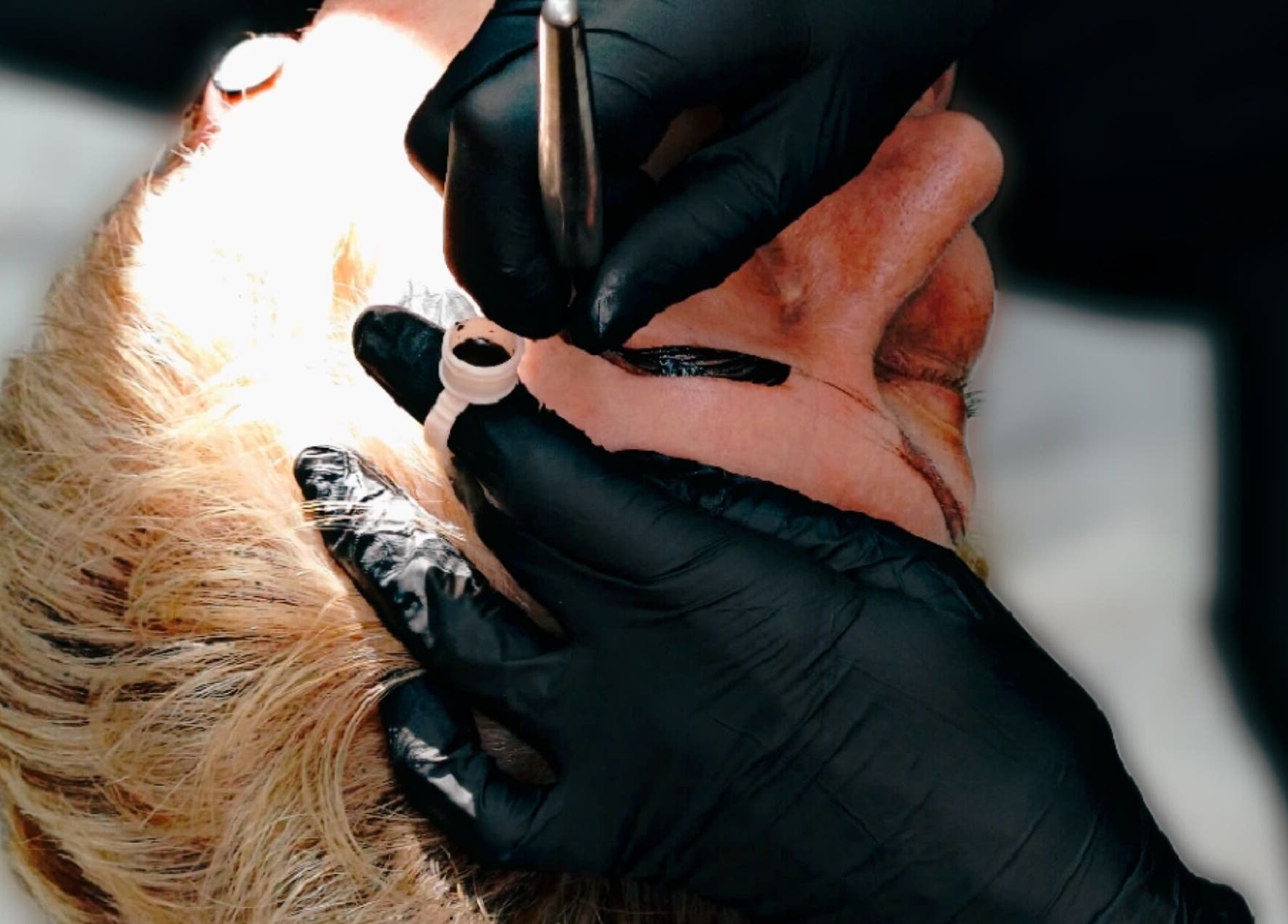 Detail of eyebrow tattooing at Inked Elegance, Randburg, Gauteng, ZA. Expert hands and tools in action.