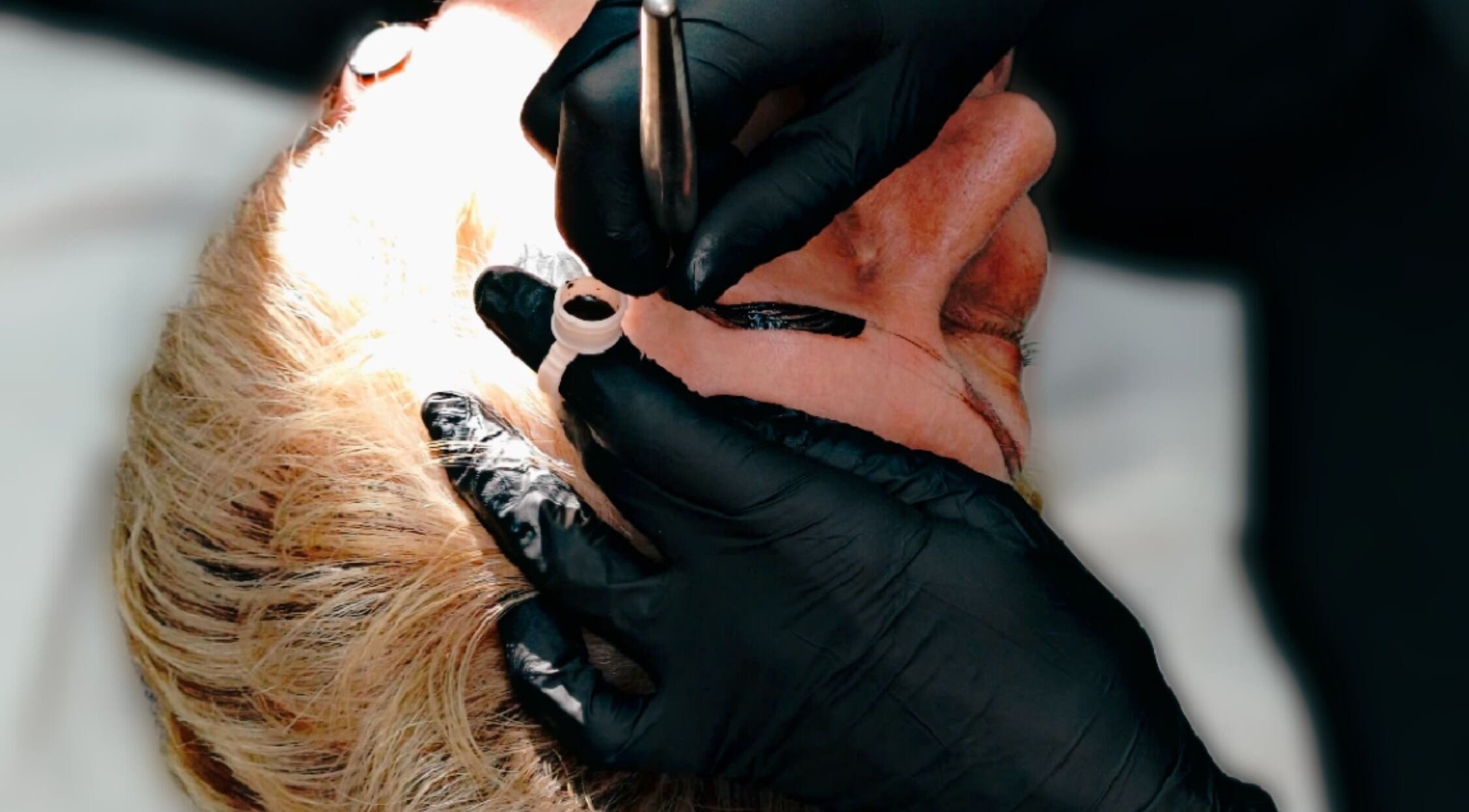 Detail of eyebrow tattooing at Inked Elegance, Randburg, Gauteng, ZA. Expert hands and tools in action.