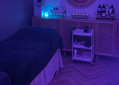 Peaceful massage room at The Holistic Haven, Swindon, England, GB, showcasing tranquil lighting and decor.