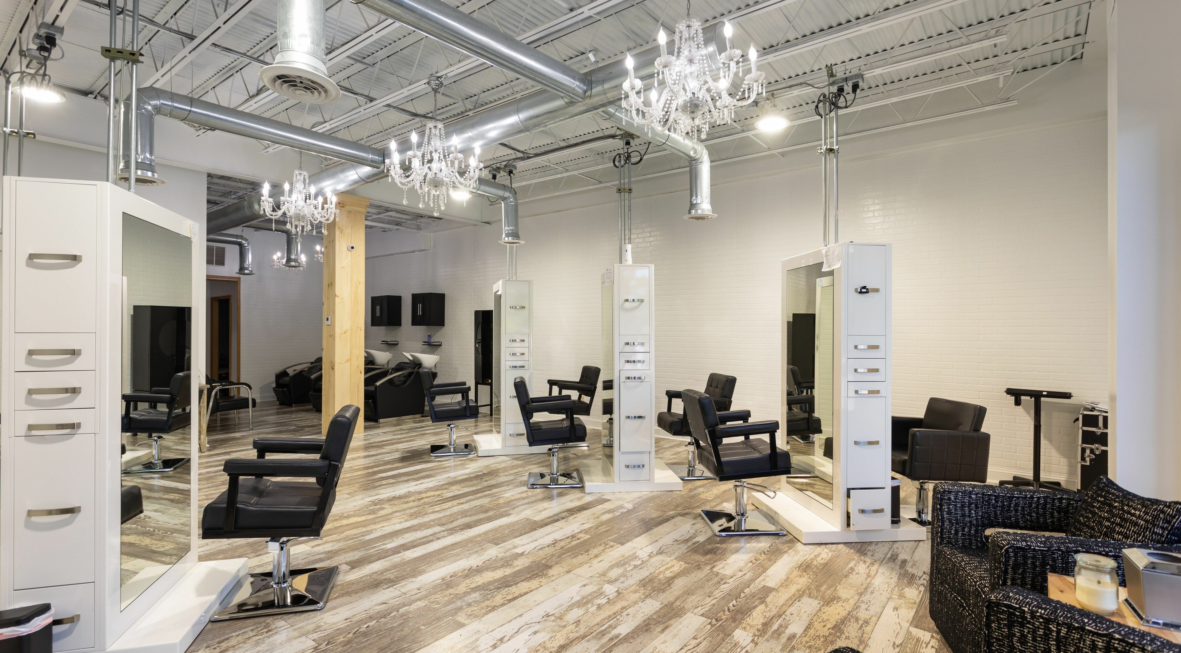 Modern interior of Dolce Hair Salon in Waterbury, Connecticut, US with stylish chairs and mirrors.