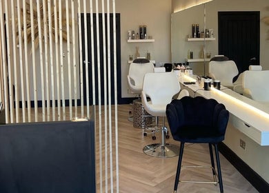 Elegant hair salon interior at By.CharleyHulme (Hair), Leeds, England, GB. Sleek chairs and modern decor.