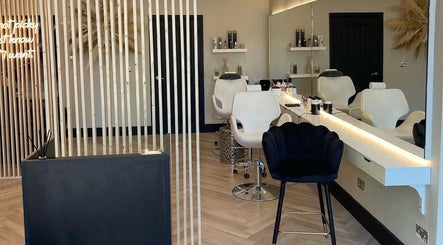 Elegant hair salon interior at By.CharleyHulme (Hair), Leeds, England, GB. Sleek chairs and modern decor.