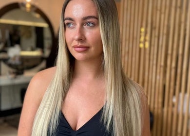 Woman with long hair at By.CharleyHulme (Hair) salon in Leeds, England, GB with modern decor.