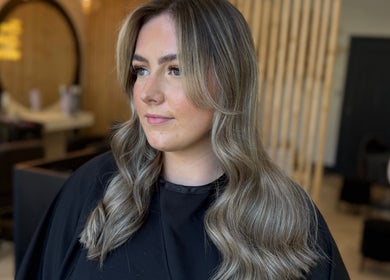 A stylish woman with wavy hair at By.CharleyHulme (Hair), Leeds, England, GB.