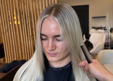 Woman with sleek blonde hair styled at By.CharleyHulme (Hair) in Leeds, England, GB.