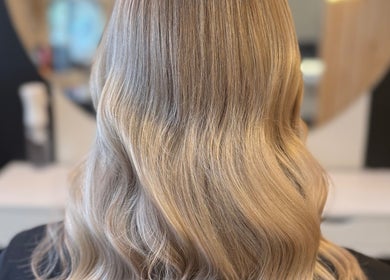 Styled wavy blonde hair at By.CharleyHulme (Hair) salon in Leeds, England, GB, showcasing expert coloring.