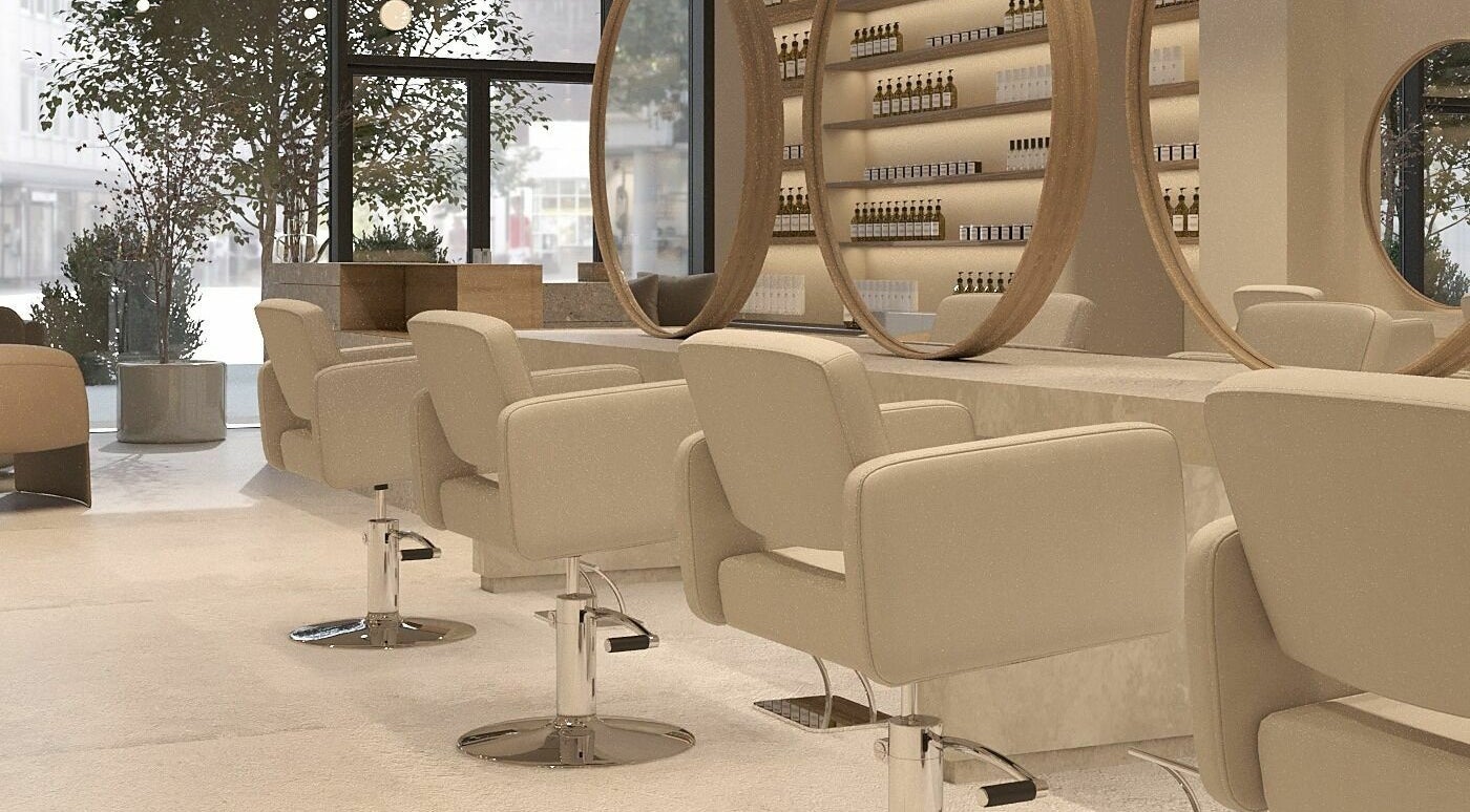 Modern interior of Her Studio Hair Salon in Santa Clara, California, US with stylish seating and mirrors.