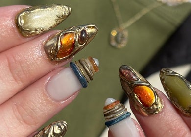 Intricate golden nail art byphoeb in Cardiff, Wales, GB, featuring metallic accents and bold designs.