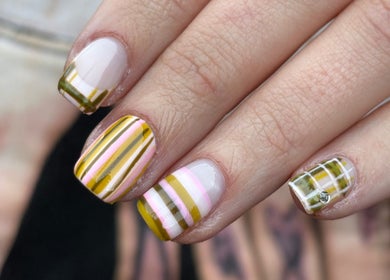 Stylish striped nail art at byphoeb, Cardiff, Wales, GB. Featuring vibrant yellow and pink design.