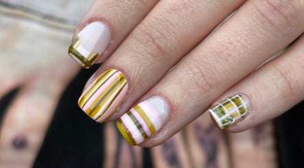 Stylish striped nail art at byphoeb, Cardiff, Wales, GB. Featuring vibrant yellow and pink design.