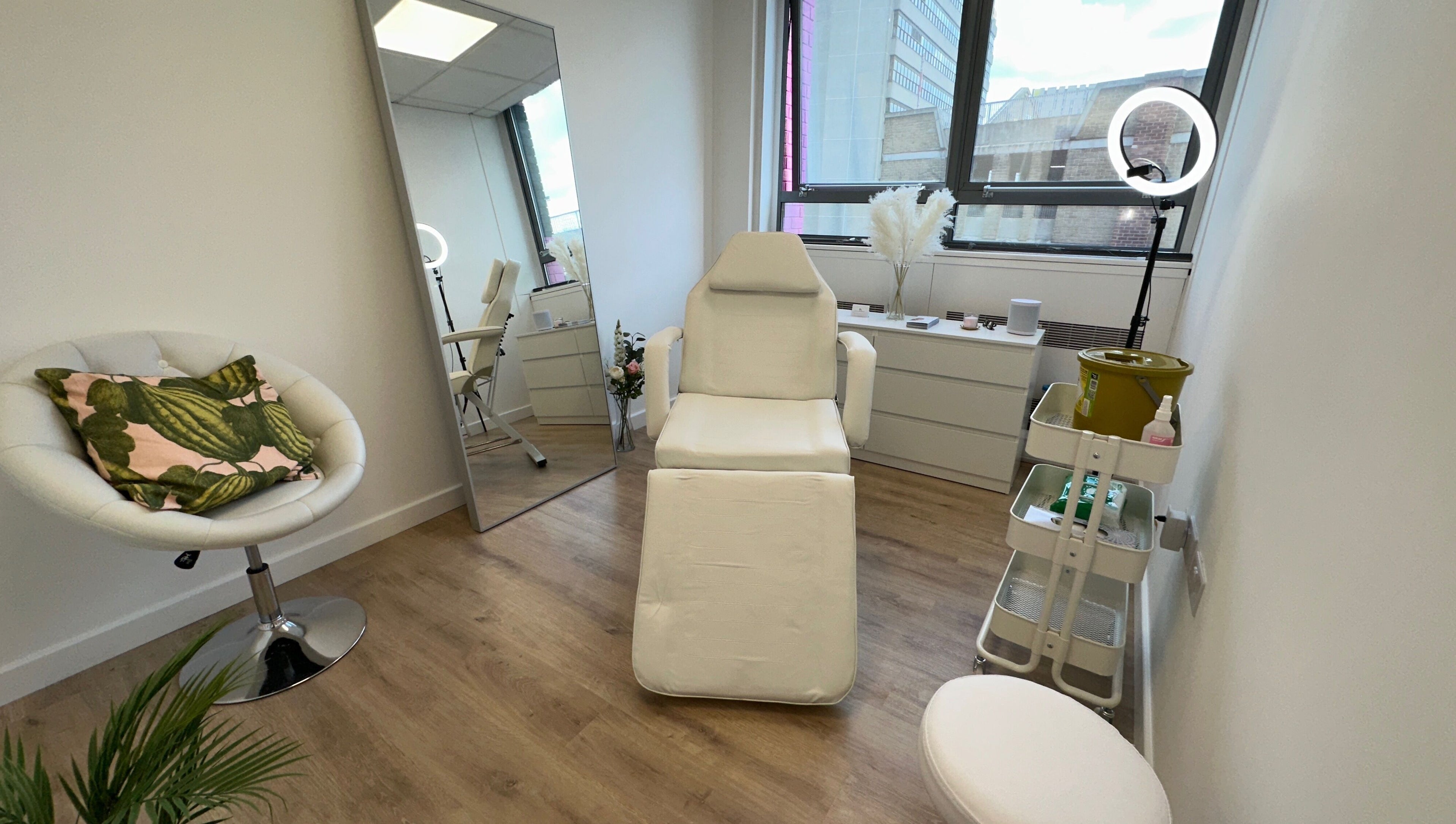 Fleur Aesthetics - East London Clinic in Barking, England. Modern treatment room with chair and mirror.