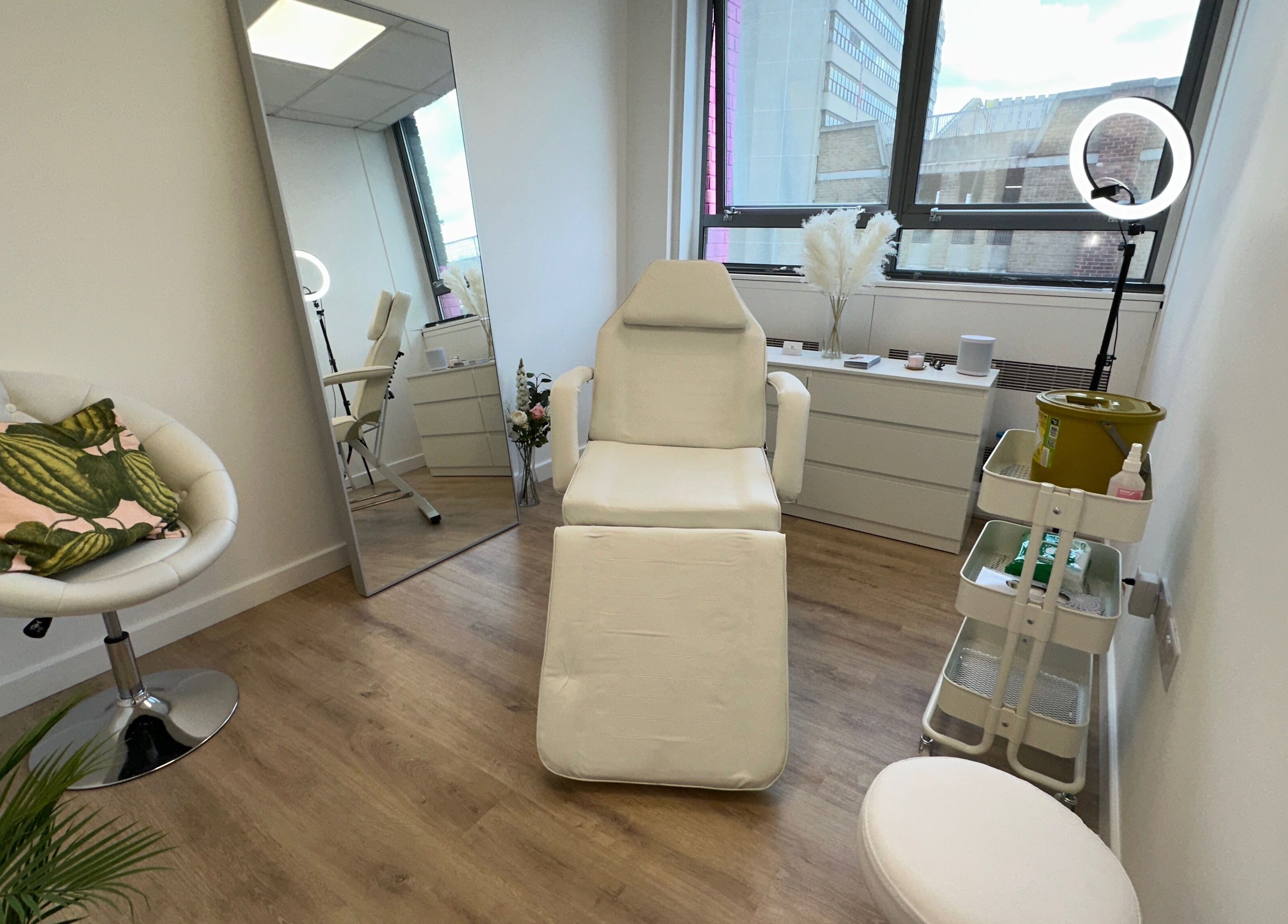 Fleur Aesthetics - East London Clinic in Barking, England. Modern treatment room with chair and mirror.