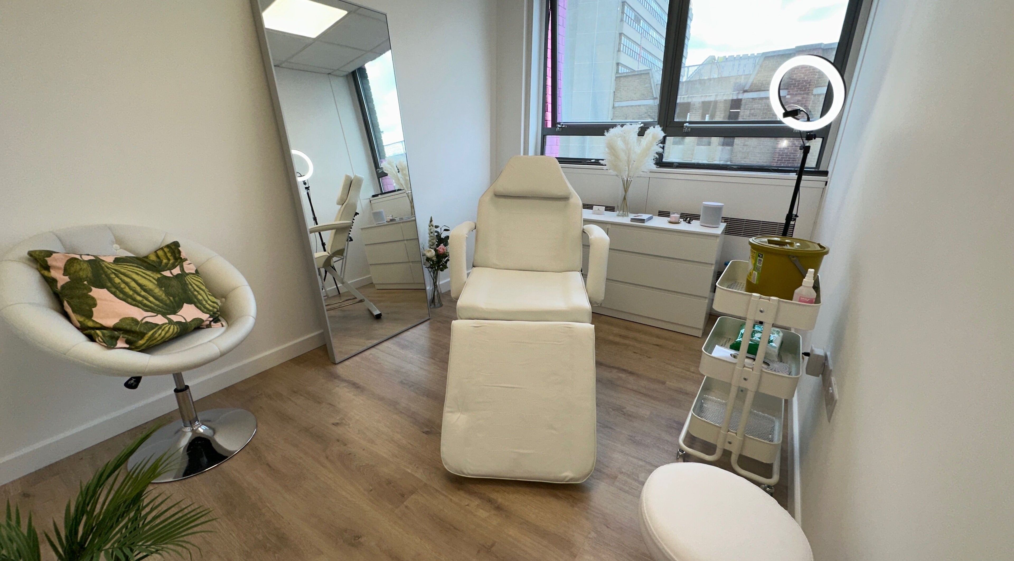 Fleur Aesthetics - East London Clinic in Barking, England. Modern treatment room with chair and mirror.