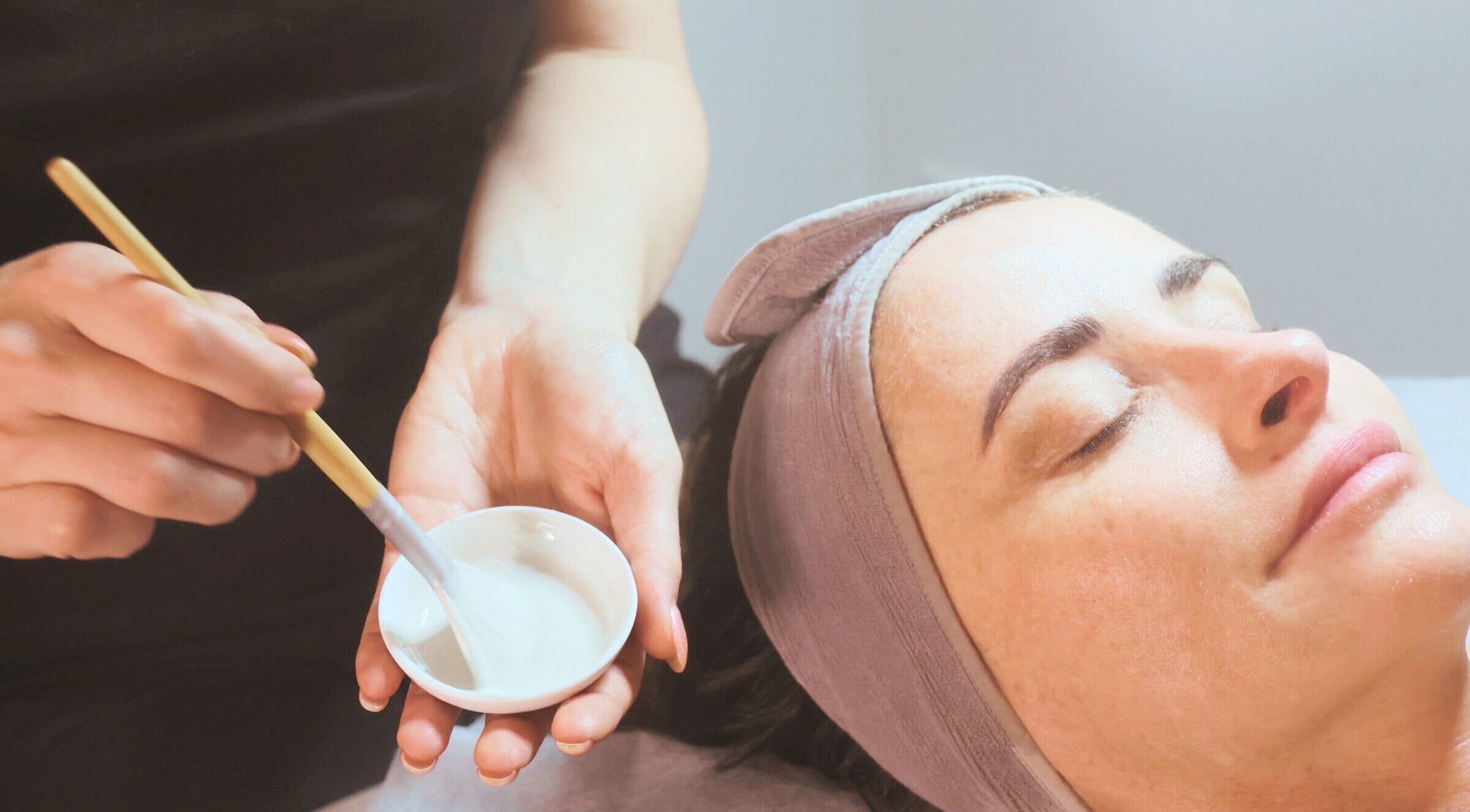 Woman receiving facial treatment at Living Skin Clinic, Merrimac, Queensland, AU.